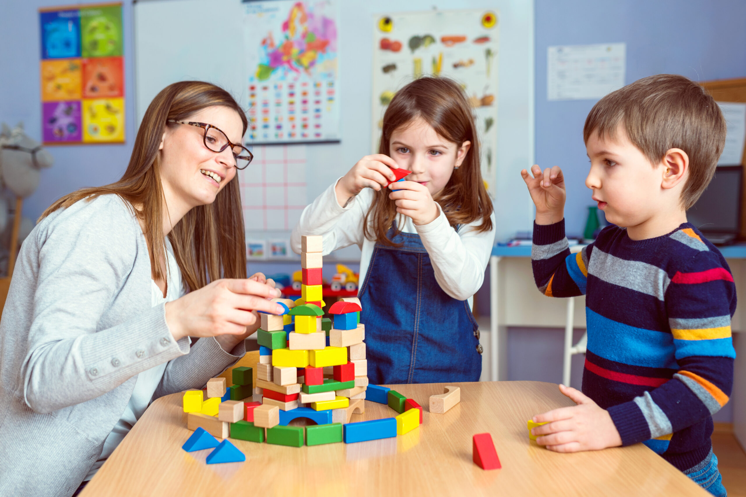 Teacher,And,Kids,Playing,Together,With,Colorful,Toy,Building,Blocks Kids learning at Bethany Academy